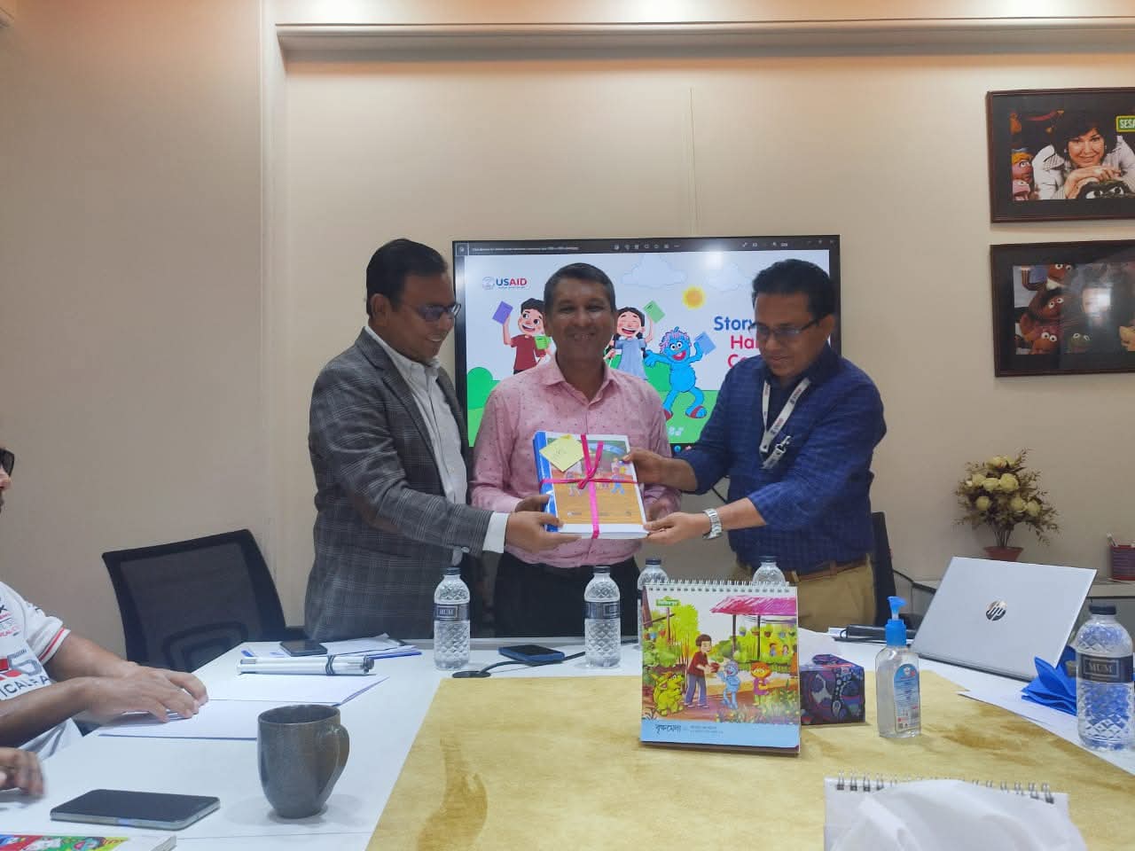 VIPS General Secretary Ashiqur Rahman Amit is receiving the Braille storybooks for distribution to visually impaired children from the Sisimpur authorities.